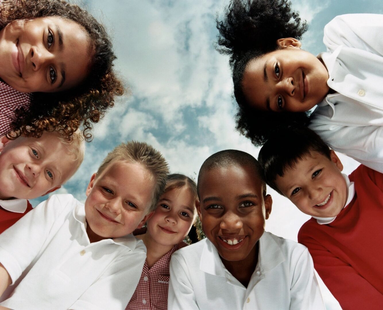 A group of children standing in the middle of each other.